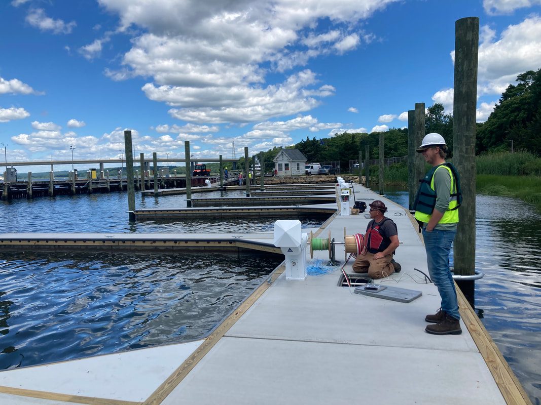 Crew in hard hats and vests working on a new floating dock