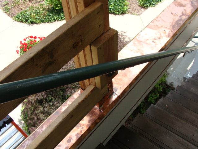 Copper flashing along the porch stair with a new handrail