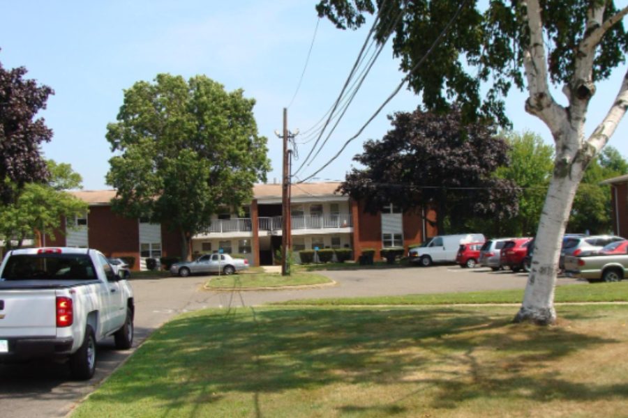 Stratford Housing Authority apartment buildings across a lawn and parking area