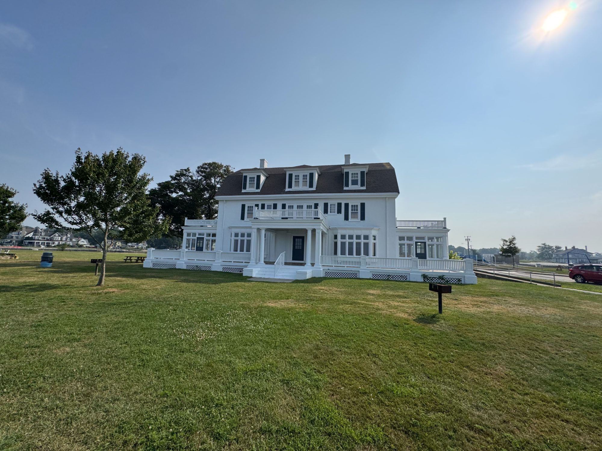 The Zbierski House across the Eastern Point Beach lawn with the Thames River shoreline beyond
